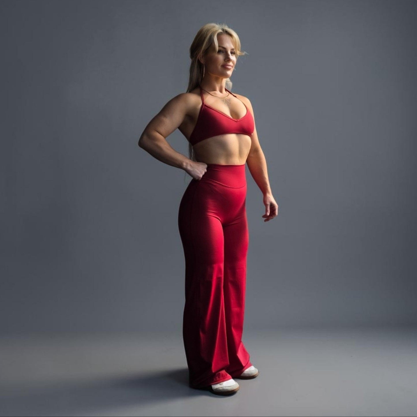 RealFitt Activewear Siren straight leg leggings in red worn by a fit woman with a matching sports bra