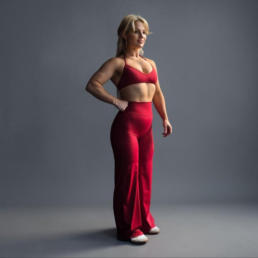 RealFitt Activewear Siren straight leg leggings in red worn by a fit woman with a matching sports bra
